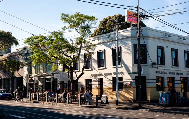 A corner pub with blue skies behind it.